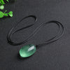 Polished green fluorite stone pendant on a black cord