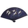 A dark blue bamboo folding hand fan decorated with white cranes flying over waves.
