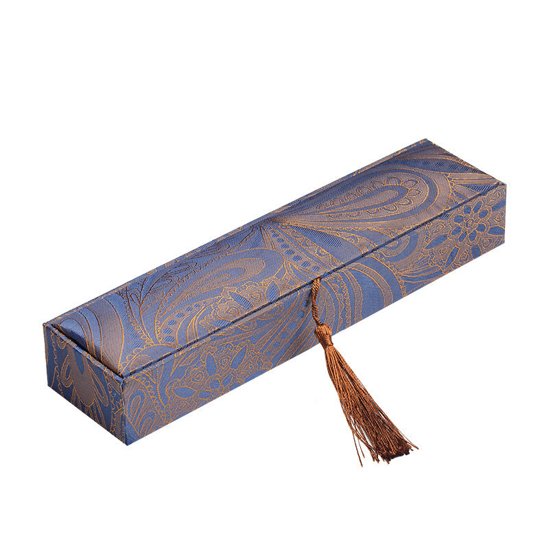 Long rectangular jewelry box with peacock blue paisley pattern and brown tassel