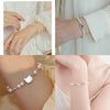 Woman wearing a freshwater pearl bracelet on her wrist