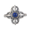 Close up of a silver ring with a blue stone in a four-pronged vajra shape