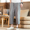 Man wearing grey loose fit linen blend pants with drawstring waist
