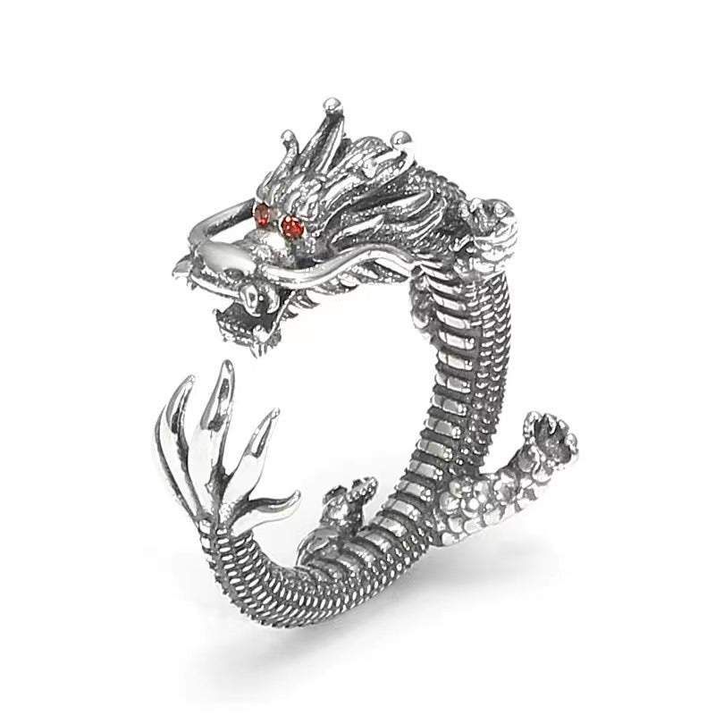 Close up view of a silver dragon shaped ring with an open band design