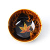 Ceramic teacup with maple leaf design and glazed finish