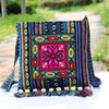 Colorful embroidered canvas crossbody bag with floral patterns and tassels