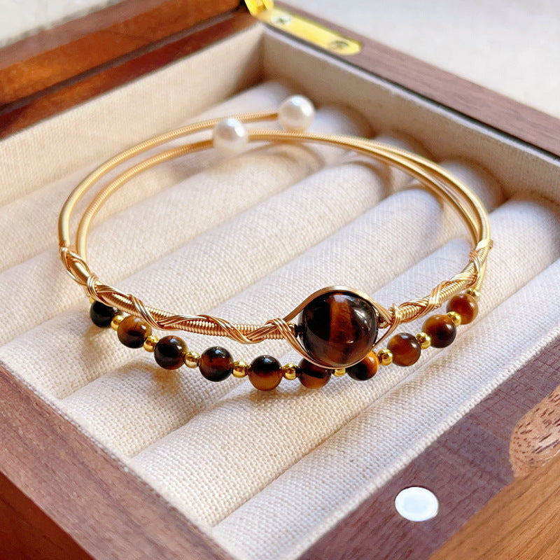 Gold wire wrapped double loop bangle bracelet with natural brown tiger eye beads and white pearls in a jewelry box