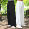 Side view of black and white loose Tai Chi pants worn outdoors