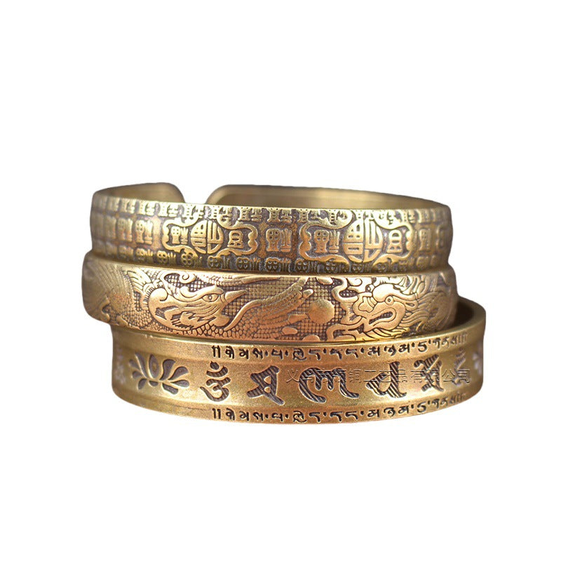 Stack of three antique brass open cuff bracelets with engraved Chinese characters and dragon designs