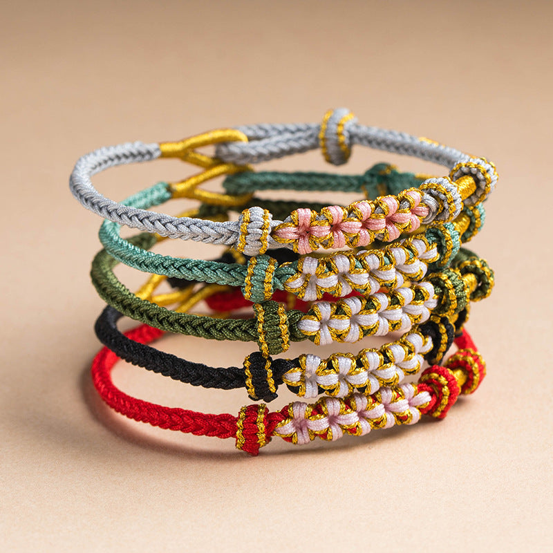 Stack of colorful hand-woven bracelets with peach blossom knots