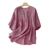 Pink cotton linen women's shirt with V-neck and half sleeves on a hanger