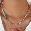Close up of a multi-colored gradient crystal necklace on a model's neck