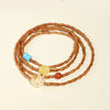 Coiled olive pit bracelet with bamboo texture and colorful accent beads