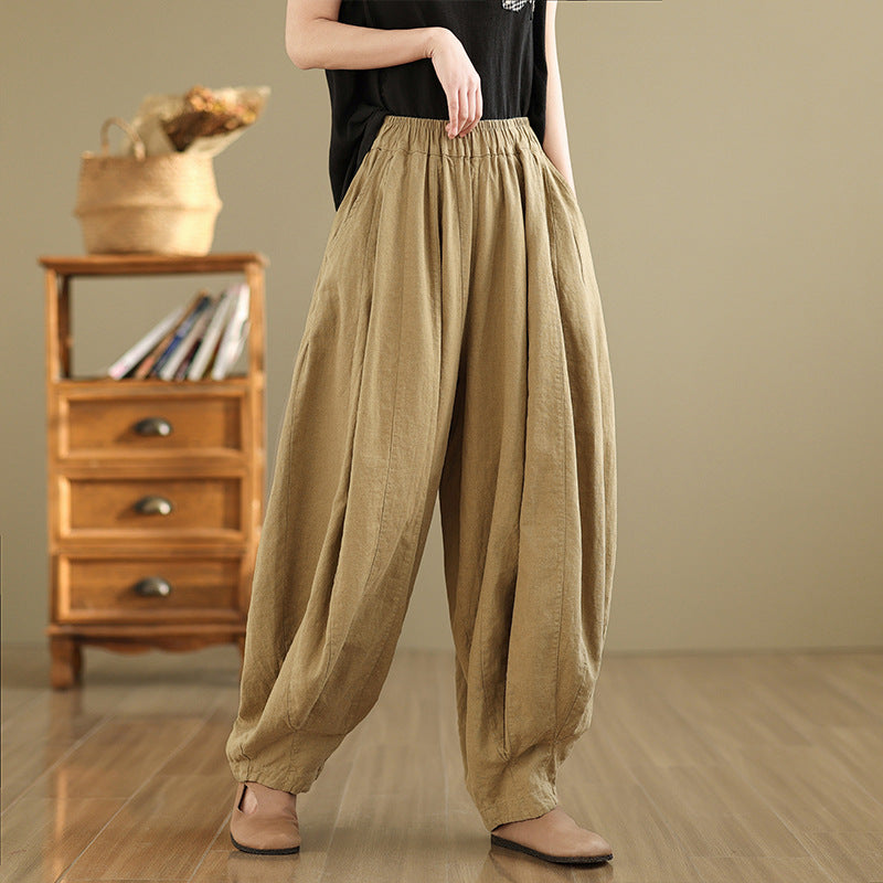 Woman wearing loose fitting beige wide leg cotton linen pants