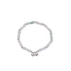 Close up of bamboo style bracelet with bells on wrist