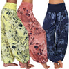 Three models wearing yellow, pink, and blue floral print harem pants