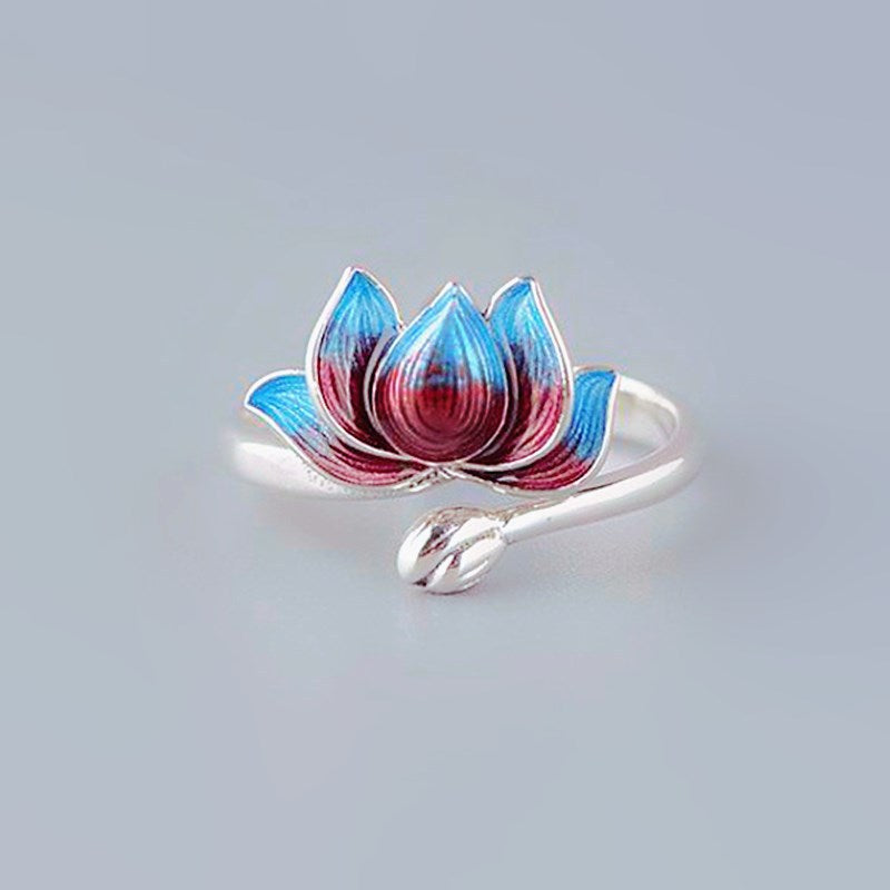 Close up of an adjustable copper ring with a blue and red lotus flower design