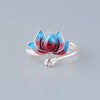Close up of an adjustable copper ring with a blue and red lotus flower design