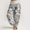 Woman wearing loose floral print harem pants with a folded high waist