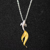 Sterling silver koi fish necklace with a gold-tone tail on a silver chain