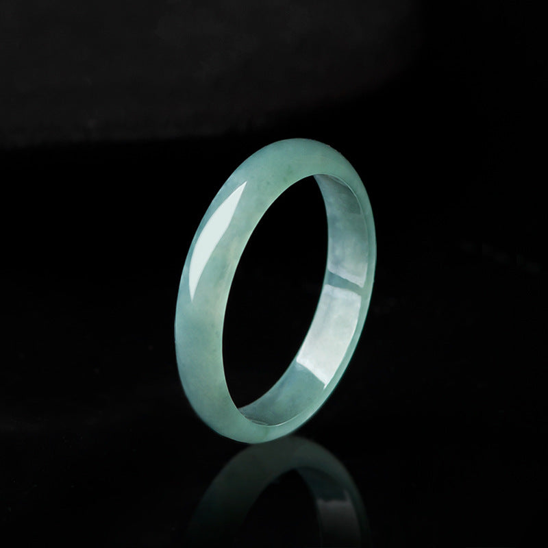 Polished natural jade ring with blue water color on black background