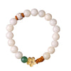White bodhi seed bracelet with a gold lotus charm and green bead on a white background