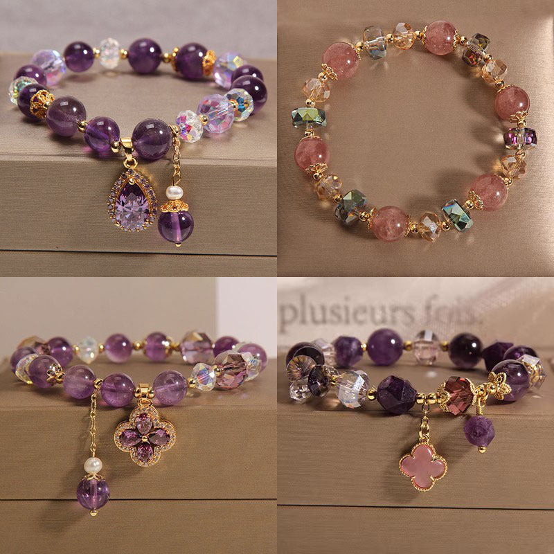 Purple amethyst beaded bracelet with a gold-tone four leaf clover charm