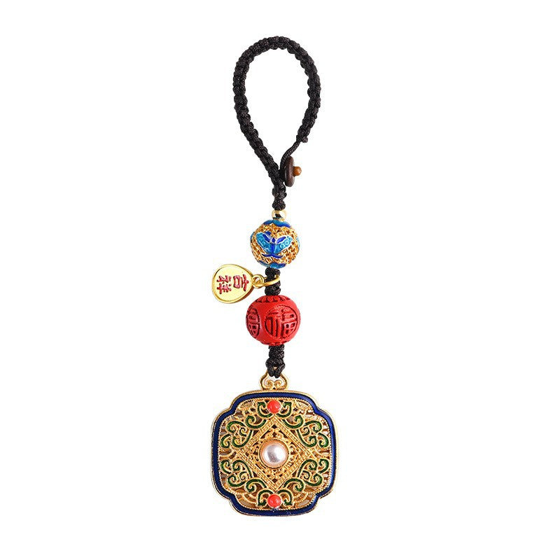 Gold-tone cloisonne enamel keychain with red beads and Fu charm attached to car keys