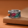 Close up of copper ring with pink lotus and orange koi fish enamel design