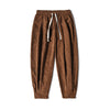 Model wearing brown corduroy harem pants with white sneakers