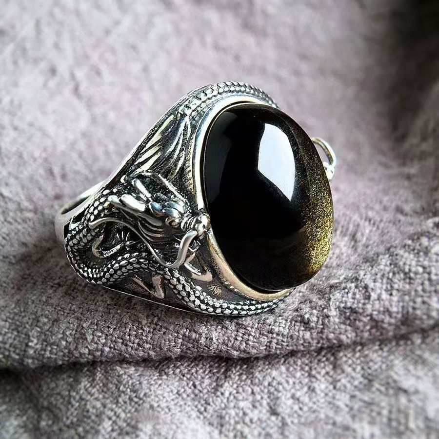 Silver-tone adjustable ring with a dragon design and a large black oval stone