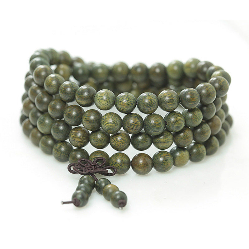 Coiled green sandalwood mala bracelet with 108 round beads and a knotted tassel