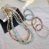 Collection of natural irregular stone necklaces and bracelets in various colors