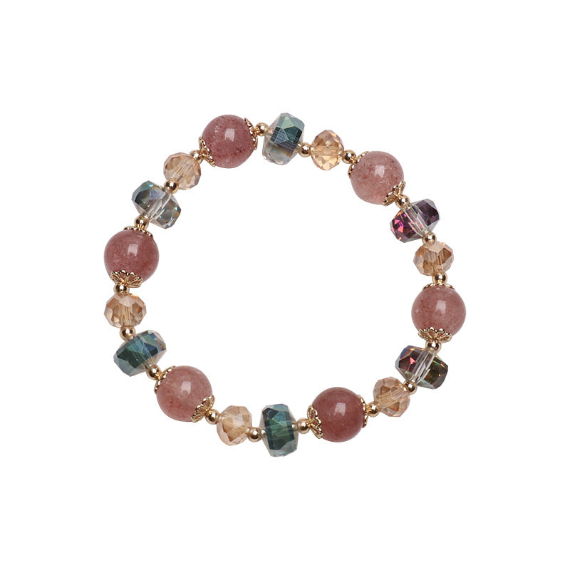 Close up of a wrist wearing a pink strawberry quartz bracelet with geometric crystal beads