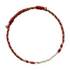 Braided red cord bracelet with silver bamboo segment charm