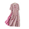 Pink floral cotton linen midi dress with short sleeves and side slit on a white background
