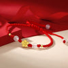 Handmade Peach Blossom Red Rope Bracelet with Gold-Tone Flower