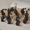 A collection of small carved wooden zodiac animal charms with blue eyes and beaded strings.