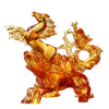 Close up of an amber glass sculpture showing a rearing horse and dragon