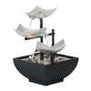 Three-tier stainless steel tabletop water fountain with flowing water and river stones in a black basin.
