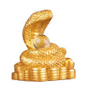Gold-tone resin statue of a coiled snake holding a sphere on a pile of coins