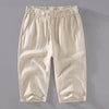 Front view of beige men's linen cropped pants with drawstring waist