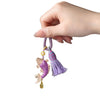 Hand holding a purple Song brocade koi fish keychain with a tassel
