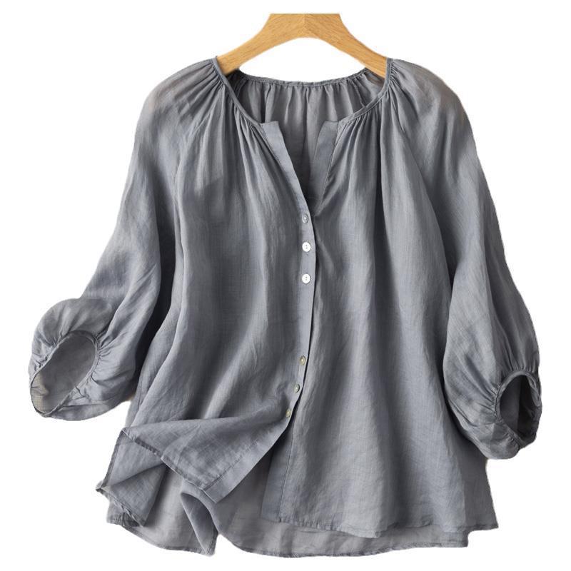 Grey vintage button-up women's shirt with three-quarter puff sleeves on a hanger
