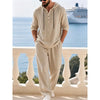 Man wearing a beige hooded lounge set with half buttons standing on a balcony