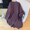 Purple cotton linen shirt with frog buttons draped over a chair