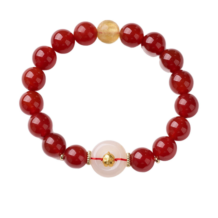 Close up of red agate bracelet with white chalcedony ring and gold foil bead