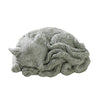 Close up of a grey ceramic sleeping fox tea pet figurine