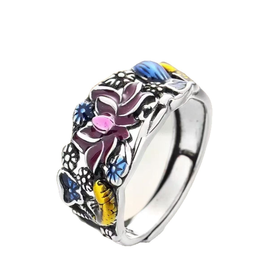 Silver tone ring with colorful enamel koi fish and lotus flower design in a blue box