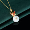 Gold tone necklace with a red and gold fox charm hanging over a white round pendant.