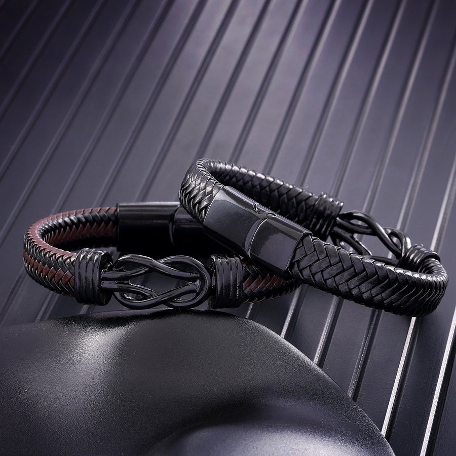 Close up of black and brown braided leather bracelet with endless knot center